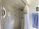 Shower featuring marbled tile, a shower head and storage for bath items at 3002 Vivienda Dr # 22, Bradenton, FL 34207