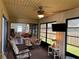 Bright sunroom with comfortable seating, ceiling fan, table with chairs and views of the interior at 3002 Vivienda Dr # 22, Bradenton, FL 34207