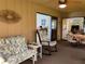 Bright sunroom with comfortable seating, ceiling fan, table with chairs and views of the interior at 3002 Vivienda Dr # 22, Bradenton, FL 34207