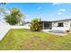 A well maintained backyard featuring a well kept lawn and white fencing at 3016 Taunton W Dr, Bradenton, FL 34205