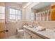 The bathroom features retro pink tile, vanity, and fixtures at 3016 Taunton W Dr, Bradenton, FL 34205