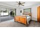 Comfortable bedroom with ceiling fan and sliding glass door access to the lanai at 3016 Taunton W Dr, Bradenton, FL 34205