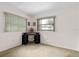 The bedroom features a corner desk with shelving and multiple windows for natural light at 3016 Taunton W Dr, Bradenton, FL 34205