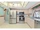 Well-maintained kitchen with stainless steel appliances, cabinets, and tiled floors at 3016 Taunton W Dr, Bradenton, FL 34205