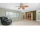 Cozy living room featuring neutral walls, tile flooring, a ceiling fan and a comfortable reclining chair at 3016 Taunton W Dr, Bradenton, FL 34205