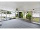 The screened-in porch features a ceiling fan and access to a hot tub for ultimate relaxation and backyard views at 3016 Taunton W Dr, Bradenton, FL 34205