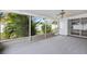 This screened-in porch offers a great space to relax with views of lush landscaping and a ceiling fan for added comfort at 3016 Taunton W Dr, Bradenton, FL 34205