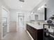 Spacious bathroom with double vanity, wood cabinets, tile floors, and recessed lighting at 3376 S Seclusion Dr, Sarasota, FL 34239