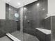 Modern glass-enclosed shower with sleek tile, built-in seating, and contemporary fixtures at 3376 S Seclusion Dr, Sarasota, FL 34239