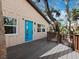 Exterior deck with stairs, a blue door, and views of the beautiful, mature tropical foliage at 3376 S Seclusion Dr, Sarasota, FL 34239