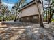 Home's exterior with trees shading the yard at 3376 S Seclusion Dr, Sarasota, FL 34239