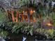 A house amongst tropical foliage and illuminated landscape lighting at 3376 S Seclusion Dr, Sarasota, FL 34239
