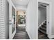 Inviting hallway leading to a screened patio with seamless access to indoor-outdoor living, plus stairway access at 3376 S Seclusion Dr, Sarasota, FL 34239