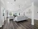 Spacious living room with vaulted ceilings, recessed lighting, and luxury wood-look floors at 3376 S Seclusion Dr, Sarasota, FL 34239
