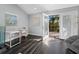 Sunlit home office with a sleek desk, comfortable seating, and access to a screened patio for added relaxation at 3376 S Seclusion Dr, Sarasota, FL 34239