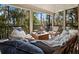 Inviting screened patio with plush seating, a cozy fire pit, and a relaxing hammock overlooking lush greenery at 3376 S Seclusion Dr, Sarasota, FL 34239
