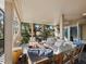 Relaxing screened patio with comfortable seating, a fire pit, and serene views of the surrounding landscape at 3376 S Seclusion Dr, Sarasota, FL 34239