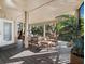 Comfortable screened patio featuring wood flooring, a hammock, and ample seating perfect for enjoying the outdoors at 3376 S Seclusion Dr, Sarasota, FL 34239