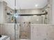 Modern tile shower with glass door, dual shower heads and pebble floor at 3376 S Seclusion Dr, Sarasota, FL 34239