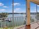 Scenic balcony view showcasing a serene lake, tropical palm trees, and nearby condo buildings at 3424 Lake Bayshore Dr # 405, Bradenton, FL 34205