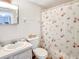 Cozy bathroom featuring a seashell-themed shower curtain, vanity, and updated fixtures at 3424 Lake Bayshore Dr # 405, Bradenton, FL 34205