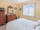 Serene bedroom featuring classic wooden dressers and a window that filters in natural light at 3424 Lake Bayshore Dr # 405, Bradenton, FL 34205