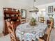 Charming dining room featuring a decorative light fixture, a china cabinet, and seating for four at 3424 Lake Bayshore Dr # 405, Bradenton, FL 34205