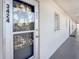 Inviting front door with decorative wreath, clear unit number and neutral exterior hallway at 3424 Lake Bayshore Dr # 405, Bradenton, FL 34205