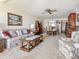 Inviting living room adjacent to the dining area, offering comfortable seating and a ceiling fan for added comfort at 3424 Lake Bayshore Dr # 405, Bradenton, FL 34205
