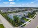 Aerial view of a well-maintained home featuring a paved driveway and lush landscaping at 3442 Chestertown Loop, Bradenton, FL 34211
