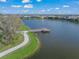 Scenic aerial view of the lake with a charming pier, providing a tranquil spot for fishing and enjoying nature at 3442 Chestertown Loop, Bradenton, FL 34211