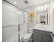 Modern bathroom features white tile shower, sink, and gray vanity at 3442 Chestertown Loop, Bradenton, FL 34211