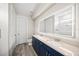 Bathroom featuring double sinks, blue cabinets and an LED illuminated mirror at 3442 Chestertown Loop, Bradenton, FL 34211