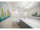 Stylish bathroom with wood-look tile, a gray vanity, and a tub-shower combination at 3442 Chestertown Loop, Bradenton, FL 34211