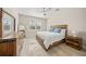 Bright bedroom showcasing a wooden bed frame, a ceiling fan, and tile flooring at 3442 Chestertown Loop, Bradenton, FL 34211