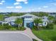 Exterior aerial view of the well-manicured community clubhouse with palm trees and lush landscaping at 3442 Chestertown Loop, Bradenton, FL 34211