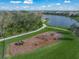 Community dog park alongside a scenic trail and lake, offering a playful and active space for furry friends at 3442 Chestertown Loop, Bradenton, FL 34211