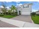Charming two-story home with a well-manicured lawn, brick driveway, and beautiful landscaping at 3442 Chestertown Loop, Bradenton, FL 34211
