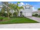 Charming two-story home with a well-manicured lawn, lush landscaping, and a welcoming front entrance at 3442 Chestertown Loop, Bradenton, FL 34211
