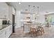 Modern kitchen featuring white cabinets, stainless steel appliances, and a stylish kitchen island at 3442 Chestertown Loop, Bradenton, FL 34211