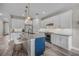 Modern kitchen featuring white cabinets, stainless steel appliances, and a stylish kitchen island at 3442 Chestertown Loop, Bradenton, FL 34211