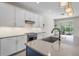 Modern kitchen featuring white cabinets, stainless steel appliances, and a stylish kitchen island at 3442 Chestertown Loop, Bradenton, FL 34211
