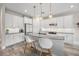 Modern kitchen featuring white cabinets, stainless steel appliances, and a stylish kitchen island at 3442 Chestertown Loop, Bradenton, FL 34211