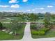 Beautifully landscaped walkway leading to a peaceful lake view, offering a scenic escape within the community at 3442 Chestertown Loop, Bradenton, FL 34211