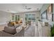 Bright living room features a ceiling fan, comfortable seating and sliding glass doors to the outdoor pool area at 3442 Chestertown Loop, Bradenton, FL 34211