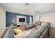 Stylish living room featuring an entertainment center, hardwood floors, and a large sofa at 3442 Chestertown Loop, Bradenton, FL 34211