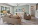 Cozy living room with a view to the lanai with comfortable seating and stylish decor at 3442 Chestertown Loop, Bradenton, FL 34211