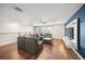 Spacious living room boasts hardwood floors, modern ceiling fan, and entertainment center on an accent wall at 3442 Chestertown Loop, Bradenton, FL 34211