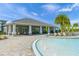 Outdoor lounge by the pool with covered seating, tall columns and beautiful palm trees at 3442 Chestertown Loop, Bradenton, FL 34211