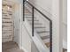 Modern staircase with metal cable railings and wooden steps, ascending to the upper level at 3442 Chestertown Loop, Bradenton, FL 34211